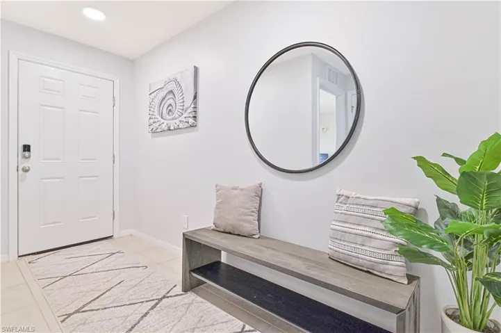 Entrance foyer featuring light tile patterned floors and recessed lighting