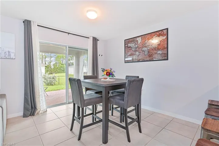 Dining room featuring baseboards and light tile patterned flooring