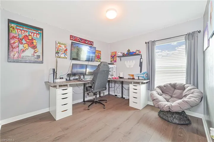 Office area featuring baseboards and wood finished floors