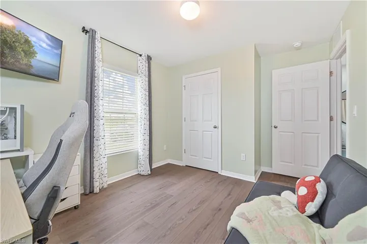 Home office with wood finished floors and baseboards