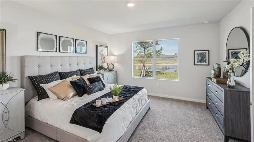 Carpeted flooring, recessed lighting, and a large window with exterior scenery