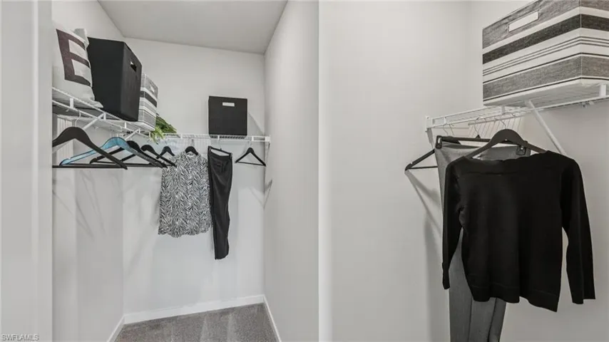 Dual-tiered wire shelving provides storage, complemented by a wire hanging rod