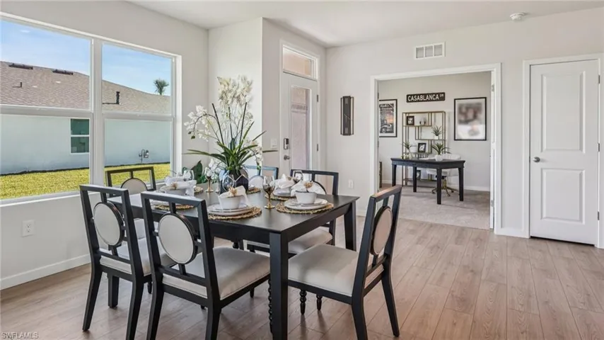 Wood-finish flooring, large windows, recessed lighting, and a neutral wall color