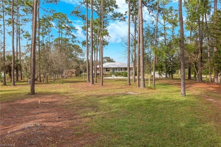 The home is located at the rear of the partially wooded 1 acre lot.