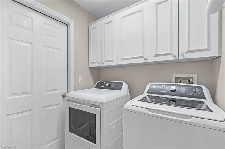 Clothes washing area with washing machine and clothes dryer and cabinets