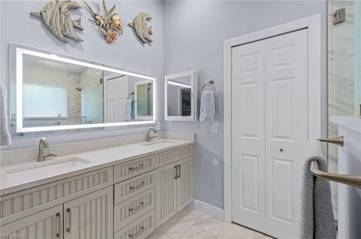 Bathroom with vanity and a shower with door