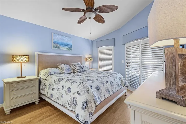 Bedroom with vaulted ceiling, light hardwood / wood-style flooring, and ceiling fan