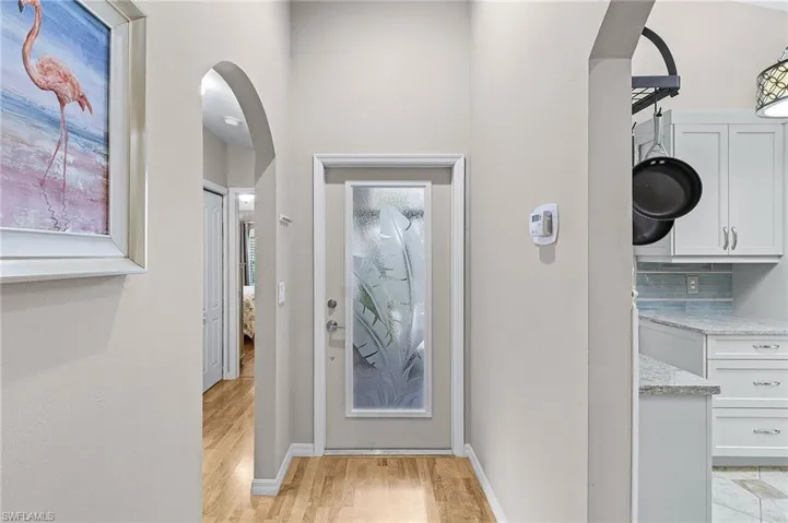 Doorway with light hardwood / wood-style flooring