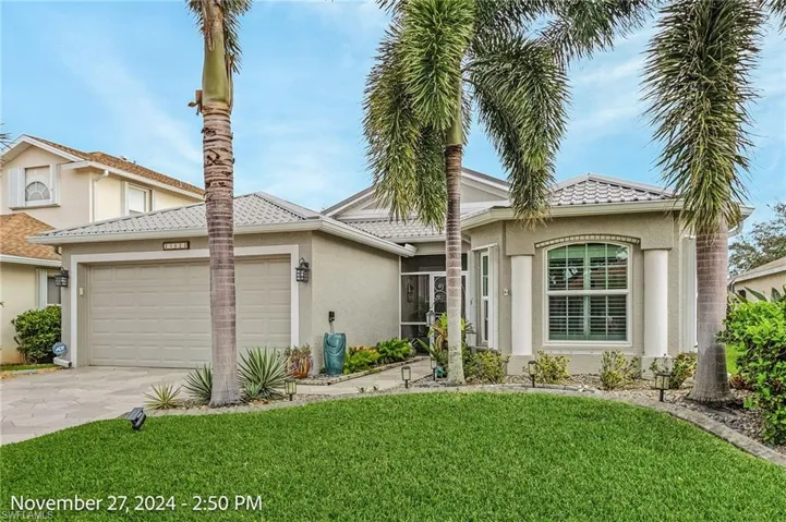 View of front of home featuring a front yard and a garage