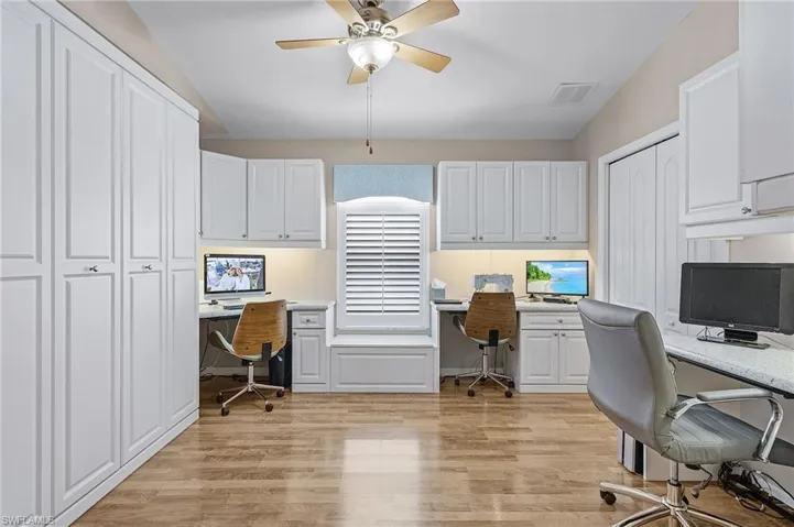 Office area with lofted ceiling, ceiling fan, and light wood-type flooring