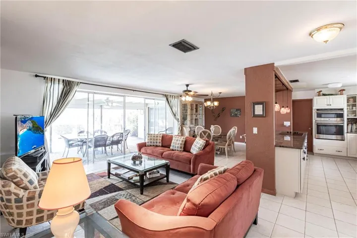 Living/dining area featuring sliding doors that open to the lanai pool area
