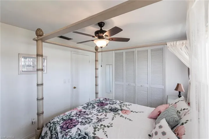 Bedroom with ceiling fan and a closet