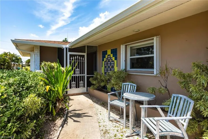 Entrance to property featuring stucco siding