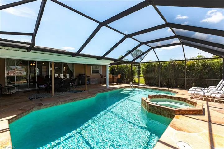 View of pool featuring a large covered lanai
