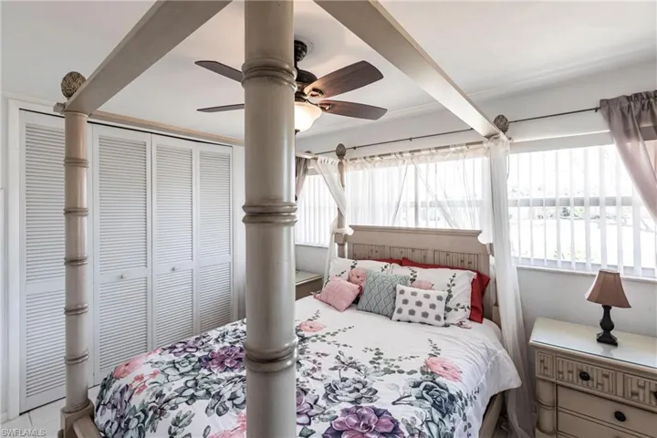 Bedroom featuring a closet, a ceiling fan, and tile patterned floors