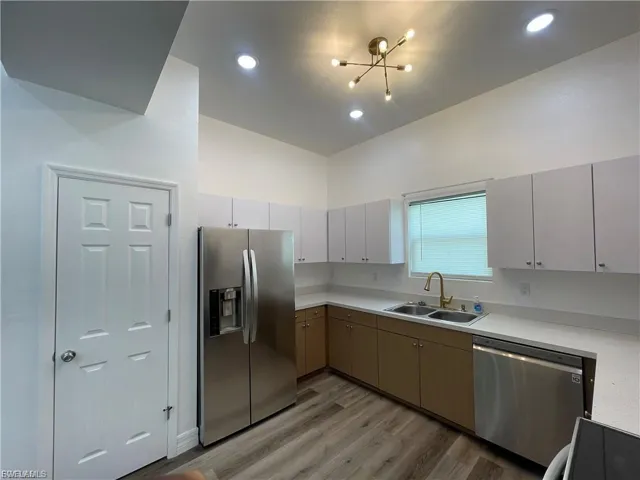 Kitchen with appliances with stainless steel finishes, light countertops, light wood-style flooring, and recessed lighting