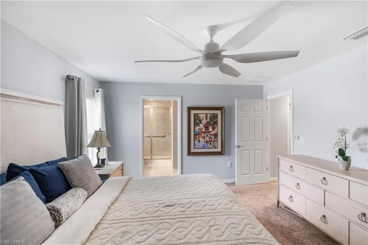 Bedroom featuring light blue walls and neutral carpeting