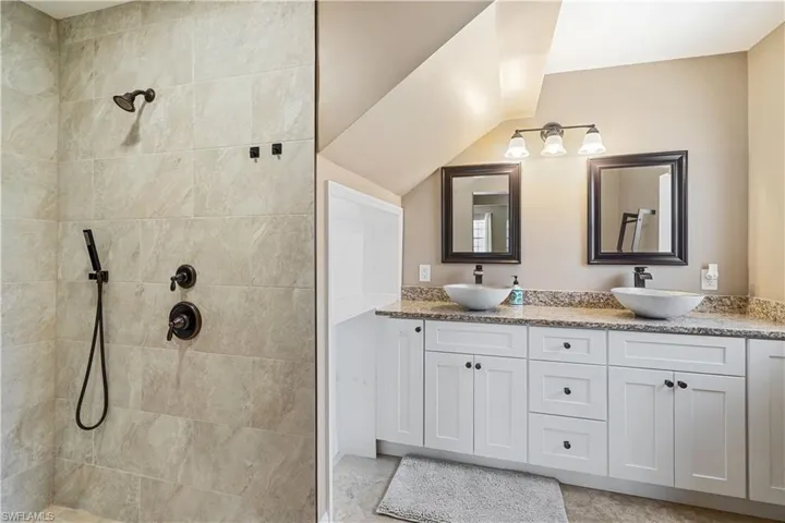 First floor primary bathroom with large walk-in shower, dual sinks, soft close cabinets and drawers