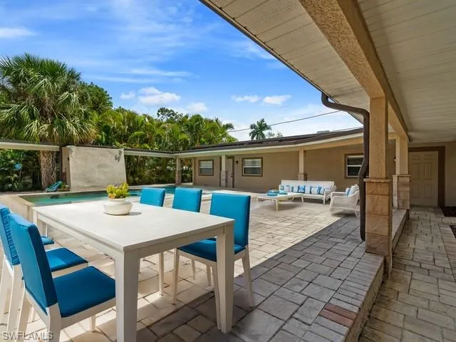 Varge terrace featuring an outdoor living space and a swimming pool