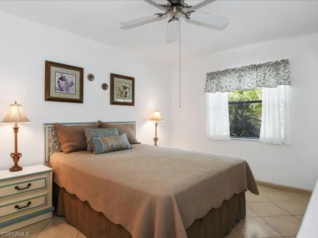 Bedroom featuring ceiling fan and light tile patterned flooring