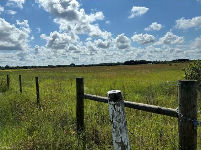 View of yard featuring a rural view and fence
