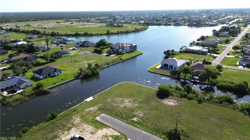 Aerial perspective showcasing the lake and canal system with multiple waterfront homes