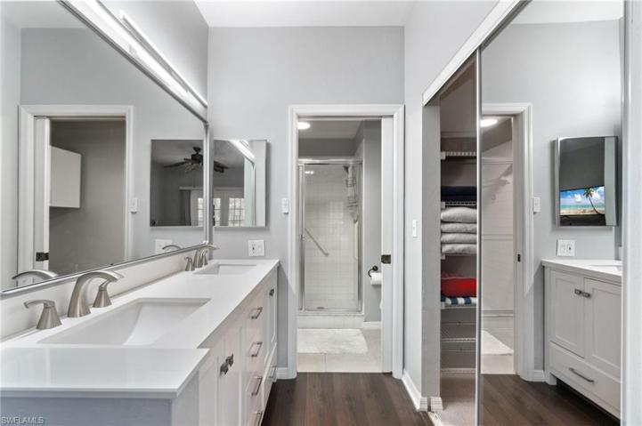 Nicely updated primary bathroom with new cabinets, double bowl sinks, new lighting, new mirror, all with a neutral look