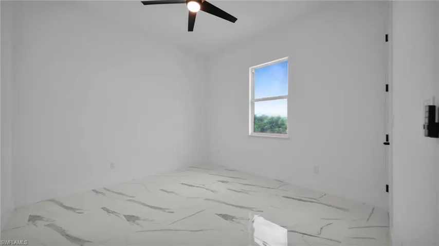 Empty room with ceiling fan and light marble finish flooring