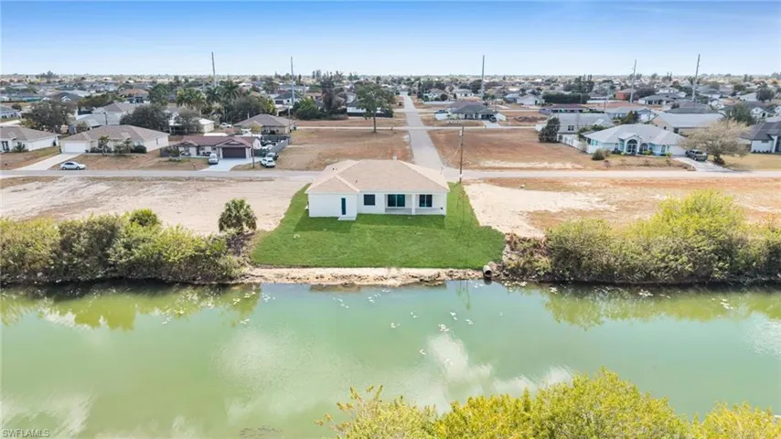 Aerial perspective of suburban area featuring a large body of water