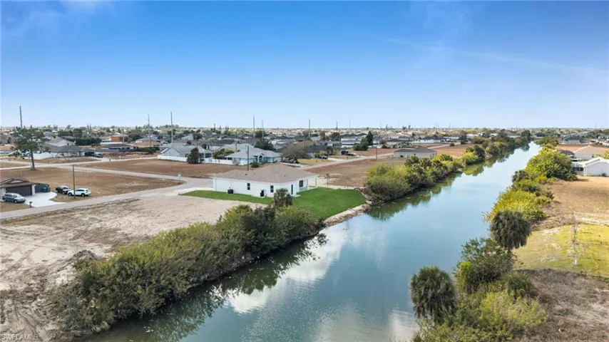 Aerial view of residential area featuring a large body of water
