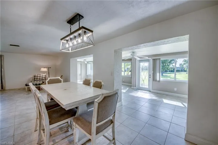 Dining area with a ceiling fan and light tile patterned floors