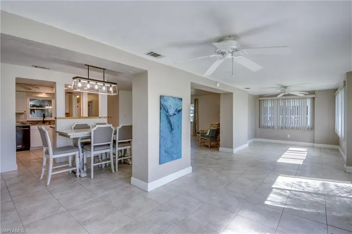 Dining room with ceiling fan and light tile patterned floors