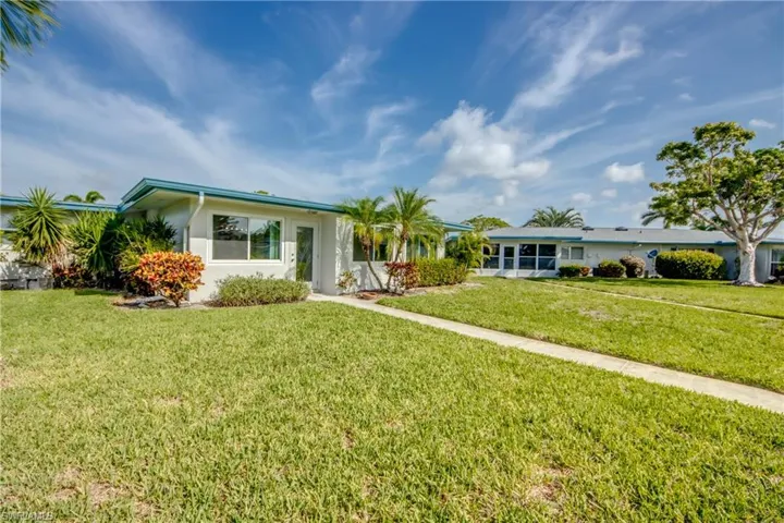Ranch-style house featuring a front yard and stucco siding