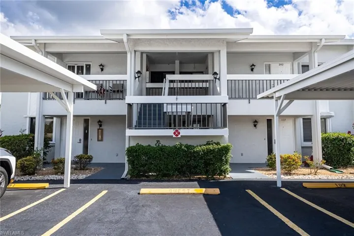 Two-story residential building with private balconies and exterior staircases