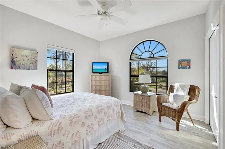 Bedroom featuring a closet, light wood-style floors, and ceiling fan