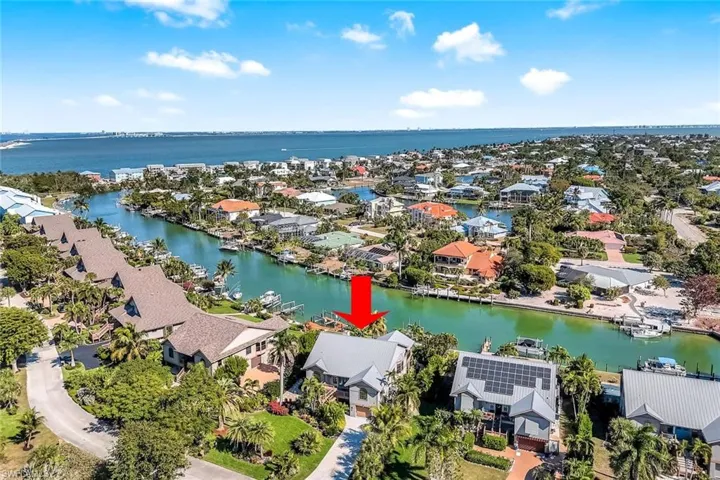 Aerial perspective of suburban area featuring a large body of water