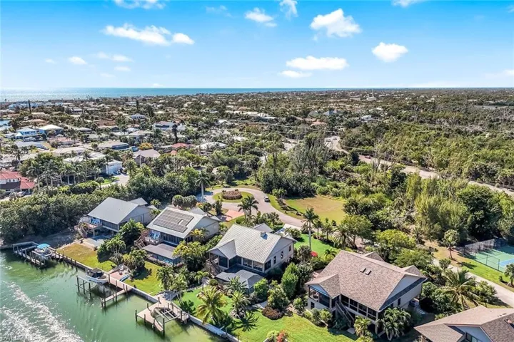 Aerial view of residential area featuring a large body of water