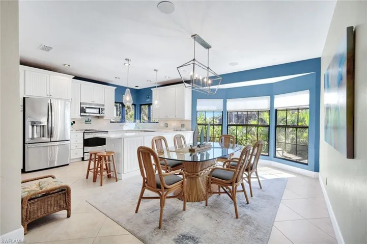 Dining room featuring light tile patterned flooring and suspended lighting