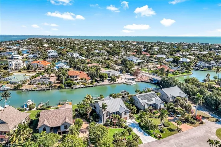 Aerial perspective of suburban area with a nearby body of water