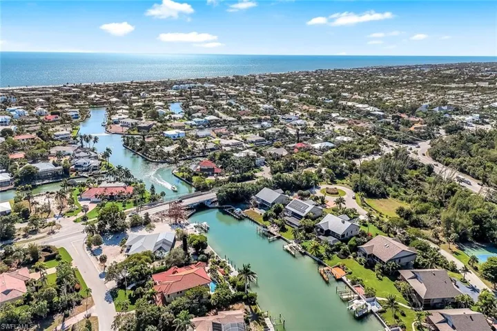 Aerial perspective of suburban area with a nearby body of water