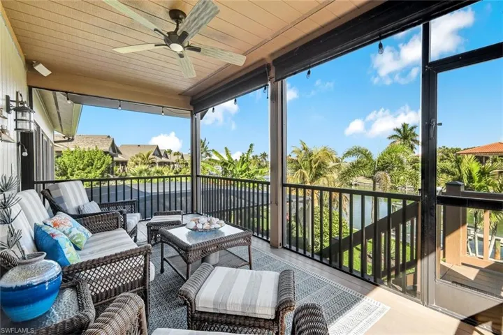 Sunroom featuring a ceiling fan, a balcony, and an outdoor lounge area