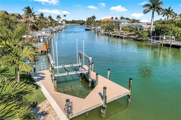 Dock area with boat lift and a water view