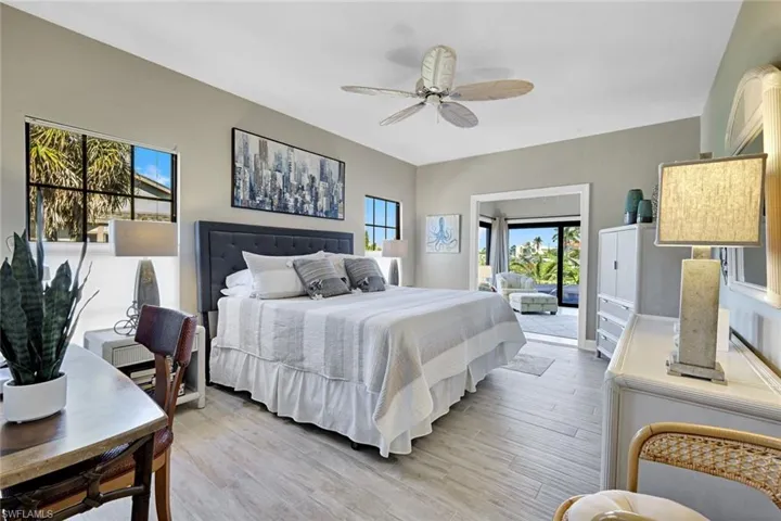 Primary Bedroom with light wood-style flooring and a ceiling fan