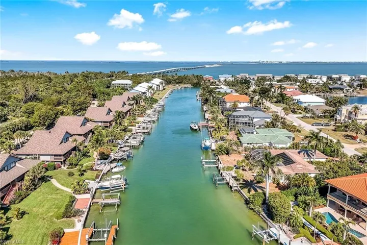 Aerial view of residential area featuring a nearby body of water