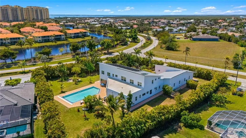 Birds eye view of property with a residential view and a water view
