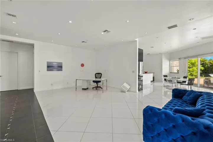 Living area with light tile patterned floors, visible vents, recessed lighting, and baseboards
