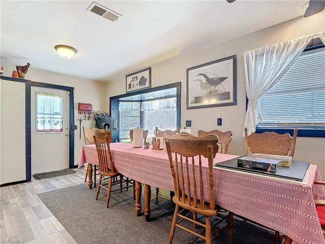 Dining area with light wood-type flooring and visible vents
