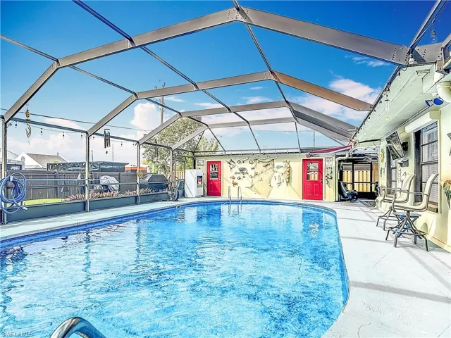 View of pool featuring a fenced in pool, a lanai, a patio, and fence