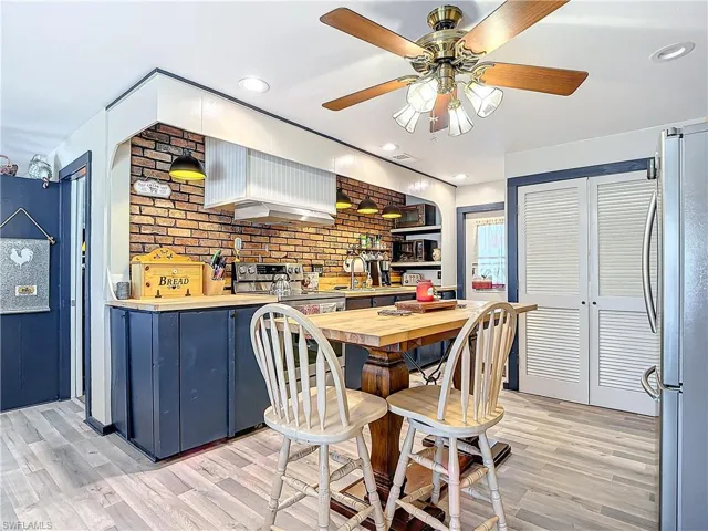 Dining space with recessed lighting and light wood-style floors