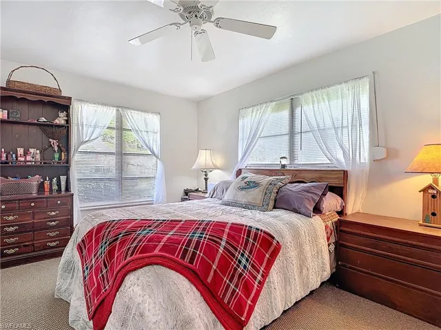 Bedroom with a ceiling fan and carpet